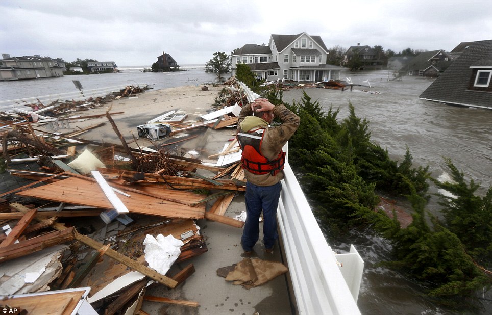 Shock: Brian Hajeski, 41, of Brick, New Jersey, reacts as he looks at debris of a home that washed up on to the Mantoloking Bridge the morning after Superstorm Sandy
